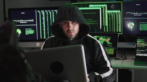 Hacker breaking into a secure network in a dark room Stock Footage 310505759