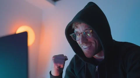 Hacker celebrating successful cyber attack on computer, cybersecurity breach Stock Footage 328350612