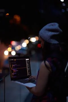 Hacker, code and night with woman and laptop screen for ransomware, cyber Stock Photos