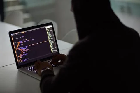 Hacker, code and programming with person and laptop screen for ransomware, cyber Stock Photos