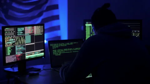 Hacker code blinks of the monitor screen. Man exhales smoke from a vape 库存影片 131160349