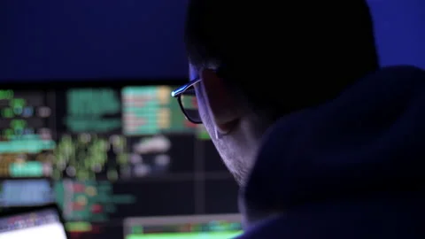 Hacker code blinks of the monitor screen. Man exhales smoke from a cigarette Stock Footage 131166798
