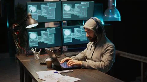 Hacker coder hacking system at night using virus 写真素材