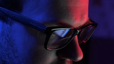 Hacker coding and programming using laptop. Man in glasses hacking on computer. Video stock 129303137