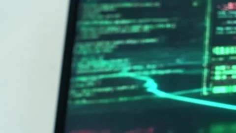 Hacker coding and writing software with green code on a computer screen Stock Footage 318444033