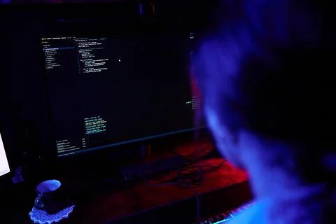 Hacker coding late night, developing cybersecurity software Stock Photos