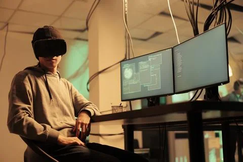 Hacker coding malicious software in virtual reality, hacking server Stock Photos