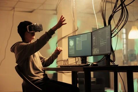 Hacker coding malware in vr glasses, hacking in metaverse Stock-Fotos