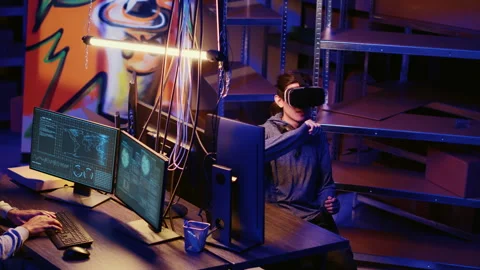 Hacker coding malware with VR headset Stock Footage 256113700