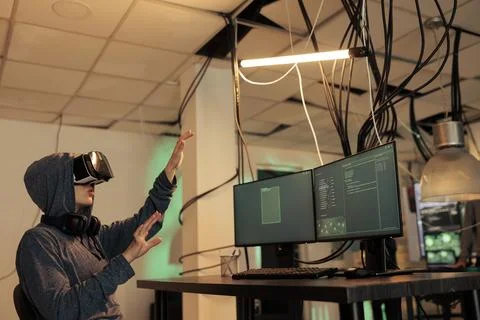 Hacker coding spyware in vr, cracking password in metaverse Stock-Fotos