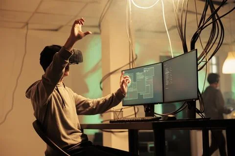 Hacker coding in vr helmet, hacking server in metaverse Stock-Fotos