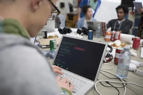 Hacker coding working hackathon at laptop Stock Photos