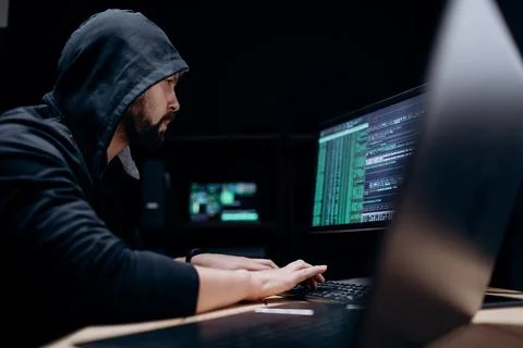 Hacker committing cybercrime Stock Photos