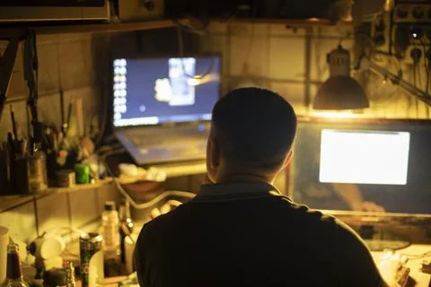 Hacker at computer. Man in dark. Stock Photos
