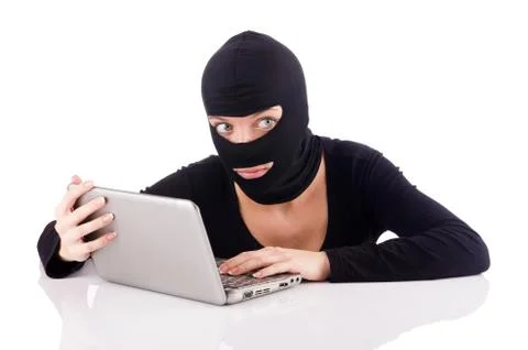 Hacker with computer wearing balaclava 写真素材