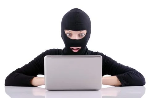 Hacker with computer wearing balaclava 스톡 사진