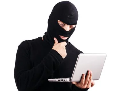Hacker with computer wearing balaclava Stockfoto's