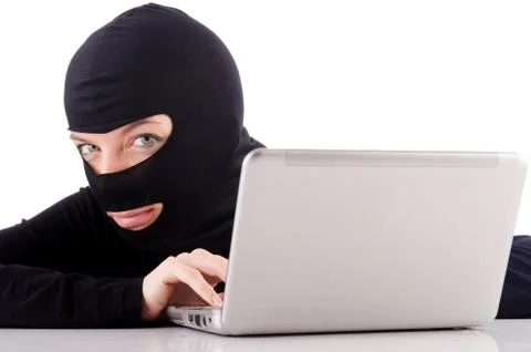 Hacker with computer wearing balaclava Foto stock