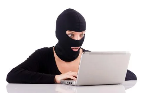 Hacker with computer wearing balaclava 库存照片