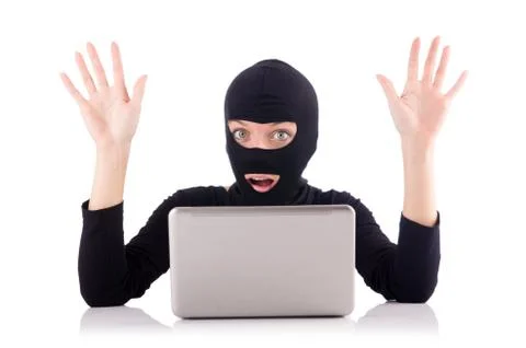 Hacker with computer wearing balaclava 스톡 사진