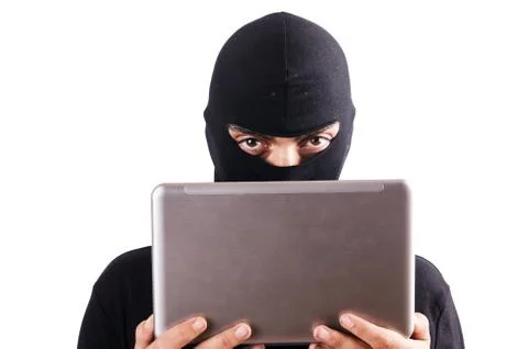 Hacker with computer wearing balaclava Stockfoto's