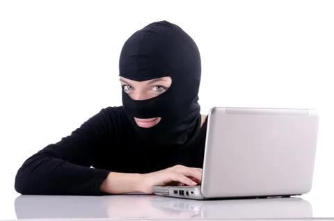 Hacker with computer wearing balaclava Stockfoto's