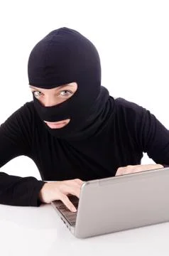 Hacker with computer wearing balaclava Stockfoto's