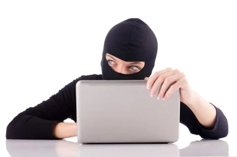 Hacker with computer wearing balaclava Stockfoto's