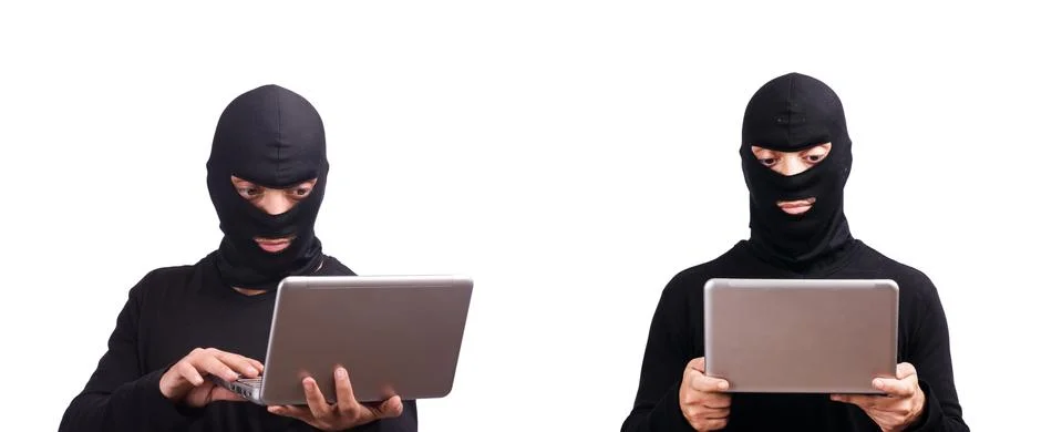 Hacker with computer wearing balaclava 스톡 사진