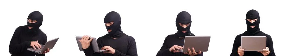 Hacker with computer wearing balaclava 스톡 사진