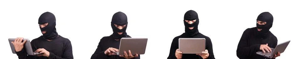 Hacker with computer wearing balaclava Stockfoto's