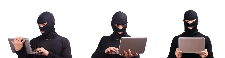 Hacker with computer wearing balaclava 스톡 사진
