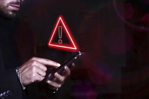 Hacker control and spying on your mobile phone. Symbol of caution in the use of Stock Photos