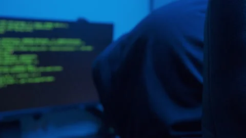 Hacker cracking code, over the shoulder view of the monitor Stock Footage 235762494