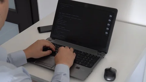 Hacker creating an aritificial intelligence software on a laptop 스톡 동영상 118302374