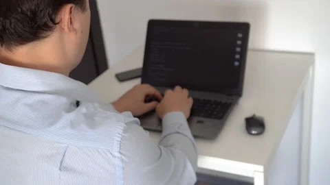 Hacker creating an aritificial intelligence software on a laptop 스톡 동영상 118305042