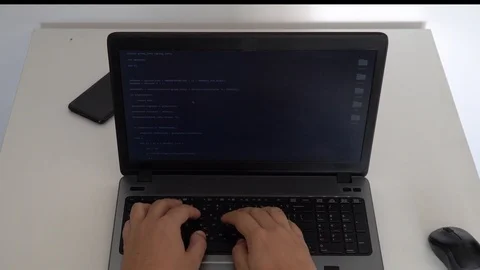 Hacker creating an aritificial intelligence software on a laptop 스톡 동영상 118309081