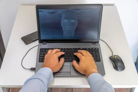 Hacker creating an artificial intelligence software program Stock Photos