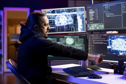 Hacker in cyber safehouse using AI to break into secure computer systems Stock Photos