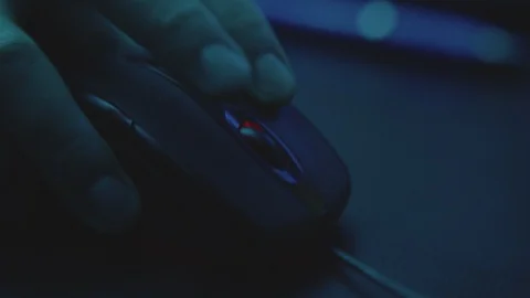 Hacker in the Dark Atmosphere is nervously using a computer mouse while stealing Stock Footage 122257762