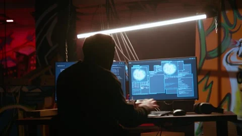 Hacker in dark neon lit underground HQ coding malware Stock Footage 319518643
