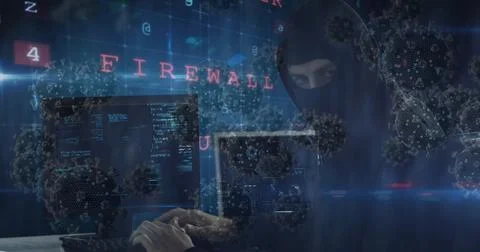 Hacker in dark room coding on laptop with virus graphics and firewall text Foto stock