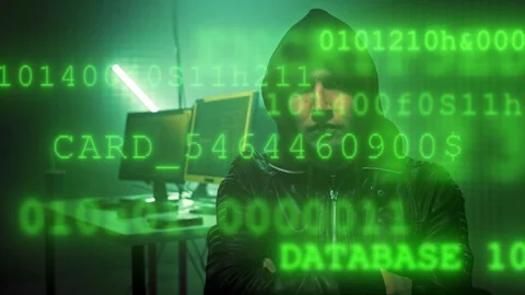 Hacker in dark room writing code or using computer virus program for cyber Stock Footage 120564247