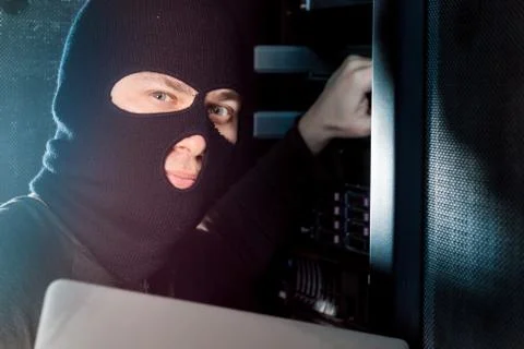 Hacker in a datacenter Stock Photos