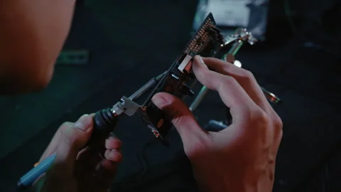 Hacker Desoldering Components From Electronic Circuit Board Stock Footage 341661125