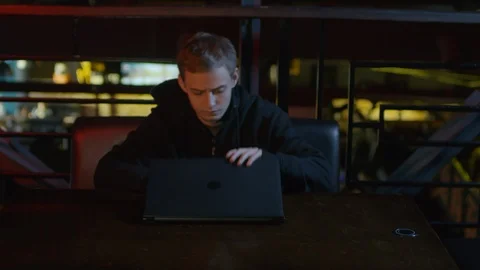 Hacker Developing Computer Code in Bar Video stock 105289214