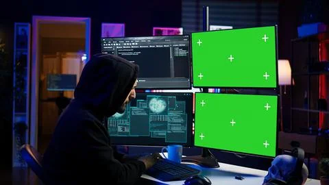 Hacker developing spyware software on green screen computer to steal data 스톡 사진