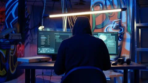 Hacker devising plan, coding malware designed to exploit network Stock Photos
