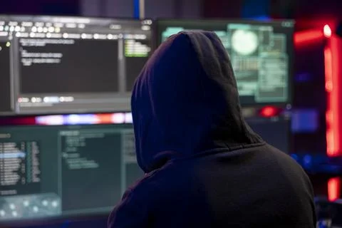Hacker doing covert operations in hideout to bypass advanced security Stock Photos