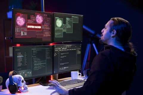 Hacker doing covert operations in secret hideaway to bypass advanced security Foto stock